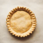 Final baked pie crust with a golden, flaky texture